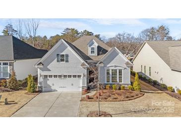 Charming home showcasing a manicured lawn, two car garage, and beautiful landscaping at 14531 Crosswater Ln, Charlotte, NC 28278