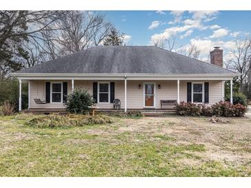 Ranch home with front porch, mature landscaping, and a spacious yard at 3219 Monte Dr, Monroe, NC 28110