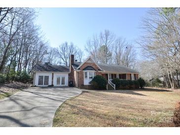 Charming single-Gathering home featuring a brick facade, bay window, and an expansive front lawn at 3303 Reid Cir, Monroe, NC 28112