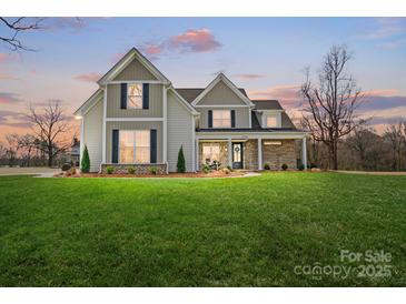 Beautiful two-story home boasting a spacious front yard and craftsman-style details at 3428 Greene Rd, Monroe, NC 28110