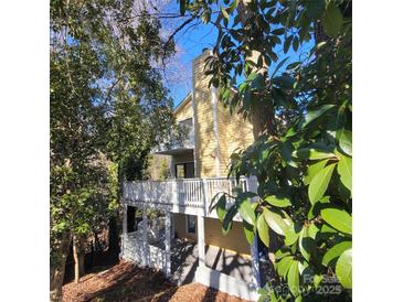 Back exterior showcasing a deck and wooded area at 4066 Triton Dr, Tega Cay, SC 29708