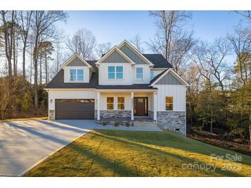 Two-story house with gray and white siding, stone accents, and a large front yard at 4827 Brookridge Ne Dr, Hickory, NC 28601