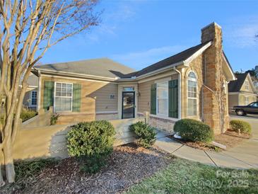 Inviting exterior of charming ranch home with stone accents and landscaping at 5573 Prosperity View Dr, Charlotte, NC 28269