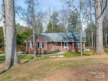 Charming brick home featuring a well-manicured lawn and mature trees at 5904 Bryant Ln, Waxhaw, NC 28173