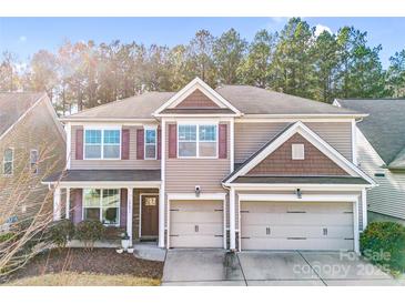 Charming two-story home featuring a two car garage, neutral colored exterior, and a cozy front porch at 79031 Ridgehaven Rd, Lancaster, SC 29720