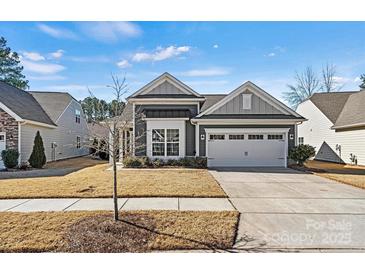 Charming single Gathering home featuring a two-car garage and a well-manicured front yard at 132 Picasso Trl, Mount Holly, NC 28120