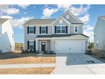 Charming two-story home featuring a two-car garage and manicured lawn at 1433 Harleston St, Indian Trail, NC 28079