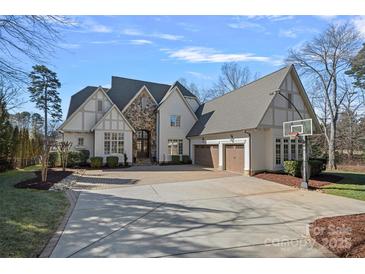 Two-story house with stone accents, three-car garage, and basketball court at 20517 Queensdale Dr, Cornelius, NC 28031