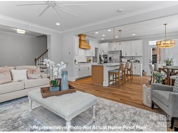 Modern kitchen with white cabinets, gas cooktop and island at 272 Gilead Rd, Huntersville, NC 28078