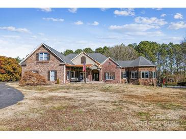 Brick home with stone accents, and a large front yard at 5645 White Store Rd, Wingate, NC 28174