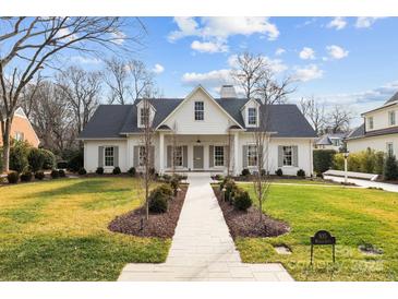 White two-story house with gray shutters, a walkway, and manicured lawn at 835 Museum Dr, Charlotte, NC 28207