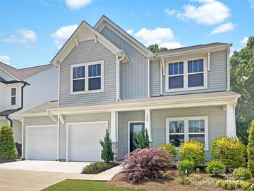 Charming home with a two-car garage and manicured landscaping offers appealing curb appeal at 128 Shay Crossing Rd, Salisbury, NC 28146
