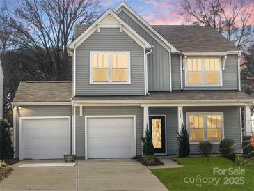 Charming two-story home featuring a three-car garage and craftsman-style details at sunset at 128 Shay Crossing Rd, Salisbury, NC 28146