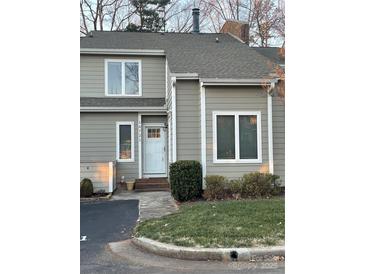 Charming home featuring neutral siding, white trim, and a welcoming front entrance on a well-manicured lawn at 16721 Spinnaker Ln, Cornelius, NC 28031