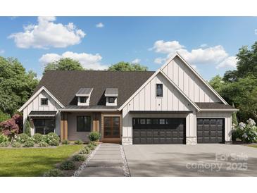Craftsman style home with gray siding, stone accents, and a two-car garage at 188 Heartland Dr # 23, Rock Hill, SC 29732