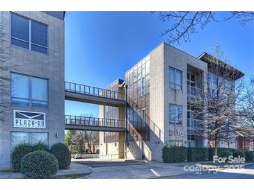 Contemporary condo building featuring walkways, modern design, and manicured landscaping at 2116 Mcclintock Rd, Charlotte, NC 28205