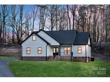 Charming exterior view showcasing the modern farmhouse design with black trim and inviting entrance at 252 Big Lick Rd, Stanfield, NC 28163