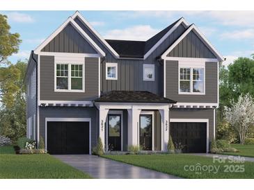 Gray two-story house with a black roof and a two-car garage at 3621 Rogers St, Charlotte, NC 28208