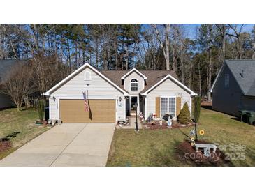 Tan two-car garage and charming front yard at 630 Montgomery Dr, Rock Hill, SC 29732