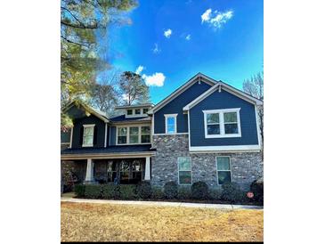 Beautiful two-story home featuring a brick facade, stylish siding, and well-manicured landscaping at 109 Belfry Loop, Mooresville, NC 28117