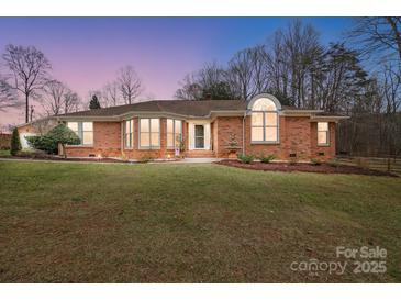 Brick ranch house with landscaped yard and large windows at 109 Rob Ln, Mooresville, NC 28117