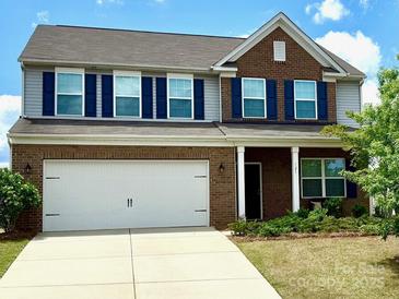 Charming two-story home featuring a two-car garage, brick accents, and a well-maintained lawn at 121 Mackinac Dr, Mooresville, NC 28117