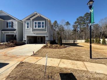 Two-story home with gray siding, attached garage, and landscaped lawn at 208 Laura Elizabeth Ln, Clover, SC 29710