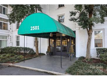 Inviting building entrance features a grand awning with prominent address numbers, promising easy identification at 2501 Roswell Ave # 303, Charlotte, NC 28209