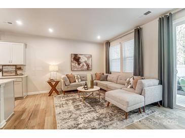 Bright living room featuring a comfortable gray sectional sofa and stylish decor at 268 Laura Elizabeth Ln, Clover, SC 29710