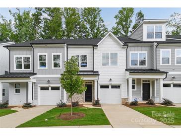 Three-unit townhome development showcasing modern gray exteriors and attached garages at 3038 Finchborough Ct # 234, Charlotte, NC 28269