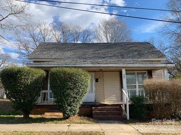 Charming one-story home with mature shrubs at 907 Sioux St, Monroe, NC 28110