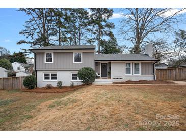 Gray exterior house with white brick accents and a landscaped yard at 1213 Hartford Ave, Charlotte, NC 28209