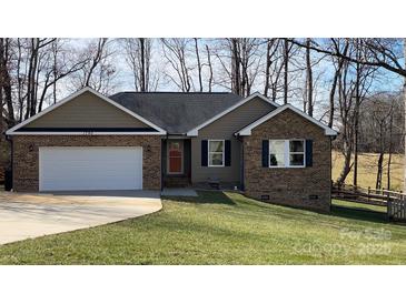 Charming single Gathering home featuring a brick and siding facade with a one car garage and well-maintained lawn at 1790 Kathy St, Newton, NC 28658