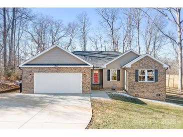 Charming brick and siding home featuring a red front door and attached two-car garage at 1790 Kathy St, Newton, NC 28658