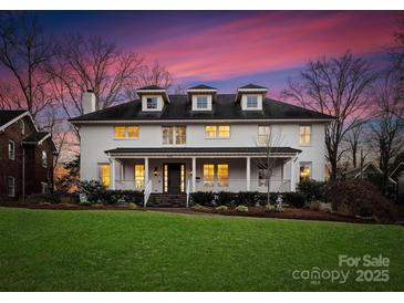 Two-story white house with a front porch and landscaped lawn at 2240 Mecklenburg Ave, Charlotte, NC 28205