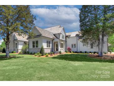 Stunning exterior with a manicured lawn and a unique blend of stone and white wood accents at 2270 New Gray Rock Rd, Fort Mill, SC 29708