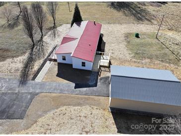 Aerial view of a single-story home with red metal roof and detached garage at 291 Patterson Farm Rd, Mooresville, NC 28115