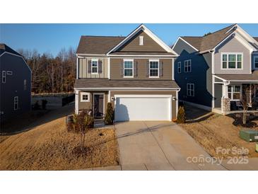 Charming two-story home with a two-car garage and manicured lawn, showcasing a welcoming facade at 3575 Cerelia Ln, Denver, NC 28037