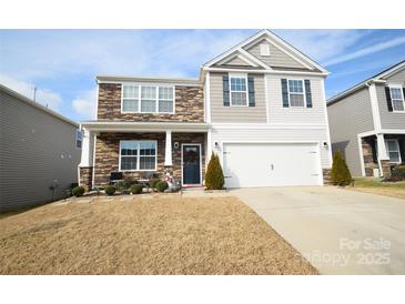 Two-story house with stone and siding, two-car garage, and landscaping at 4134 Richard Andrew Dr, Matthews, NC 28105