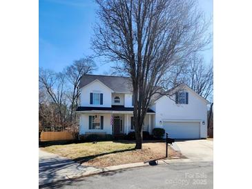 Charming two-story home with white siding, blue shutters, and a well-maintained front yard at 4763 Brockton Nw Ct, Concord, NC 28027