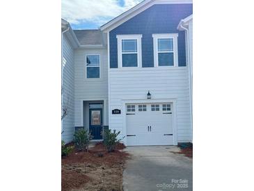 Two-story townhome with white and blue siding, two-car garage, and landscaping at 620 Cassidy Ct, Clover, SC 29710