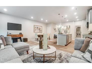 Open-concept living room and dining area features modern decor, hardwood floors, and abundant natural light at 620 Cassidy Ct, Clover, SC 29710