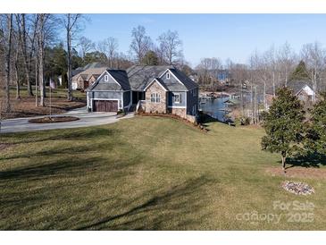 Beautiful home with stunning curb appeal, lush lawn, and lake views at 7535 Rabbit Cir, Denver, NC 28037