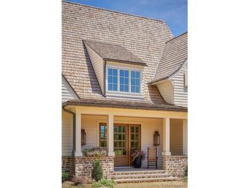 Inviting front porch and stylish wood shake roof of this charming two-story home at 961 Jw Wilson Rd, Fort Mill, SC 29715