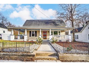 Charming home featuring a welcoming front porch and a well-manicured yard with decorative stone and cacti at 111 Academy Nw Ave, Concord, NC 28025