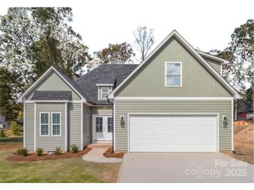 Two-story house with light green siding, white trim, and a two-car garage at 136 Autumn Blaze Rd, China Grove, NC 28023