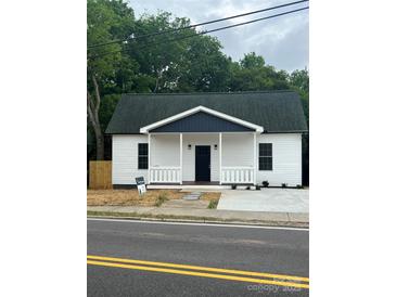 Charming home with a cozy porch and fresh landscaping, ready for its new owners to move in at 211 Brooklyn Ave, Lancaster, SC 29720