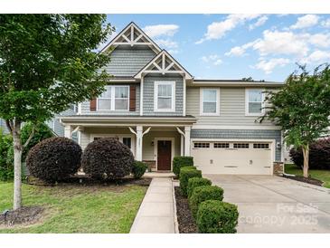 Charming two-story home with an attached two-car garage, landscaped front yard, and inviting entryway at 2201 Bluebell Way, Tega Cay, SC 29708