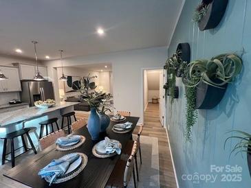 Open dining room features a large dining table with decorative place settings and access to the kitchen at 276 Laura Elizabeth Ln, Clover, SC 29710