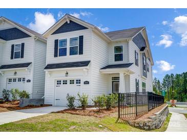 Beautiful two-story home showcasing white siding, black shutters, and a manicured lawn at 604 Cassidy Ct, Clover, SC 29710
